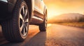 Close up tire and wheel of a car on the road in background. The driving concept of travel and vacation Royalty Free Stock Photo