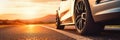 Close up tire and wheel of a car on the road in background. The driving concept of travel and vacation Royalty Free Stock Photo