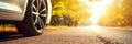 Close up tire and wheel of a car on the road in background. The driving concept of travel and vacation Royalty Free Stock Photo