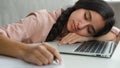 Close up tired arabian girl overworked sleepy student businesswoman falling asleep at home with laptop and notes Royalty Free Stock Photo