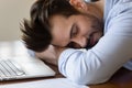 Close up tired exhausted man sleeping at work desk Royalty Free Stock Photo