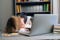 Close-up of tired pupil boy sleeping on workbook in front of laptop after online lesson via Internet Royalty Free Stock Photo