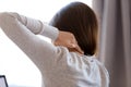 Close up tired woman massaging neck muscles after long sedentary work