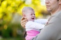 Close-up of tired young father with crying baby girl. Royalty Free Stock Photo