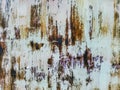 Close up to colored peeling paint texture on rusty metal surface. The old steel wall, painted and putty, peels off and collapses. Royalty Free Stock Photo