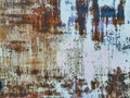 Close up to colored peeling paint texture on rusty metal surface. The old steel wall, painted and putty, peels off and collapses. Royalty Free Stock Photo