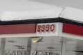 A close up to and ESSO logo during a winter snowing day