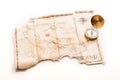 Close up to gold nautical compass on old vintage map with fake island of Pirates treasure