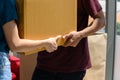 Close up to hand of young asian couple when they carrying big cardboard box while relocation into new home on moving day Royalty Free Stock Photo