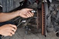 Close up to hands of a car mechanic, Concept check the disc brake condition before traveling.