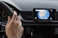 Close up to male driving and using navigation on the smartphone screen. Choose direction, globe on the screen