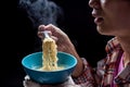 Young man hand pickup tasty noodles with steam and smoke in bowl Royalty Free Stock Photo