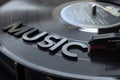 Close up to a music lettering word over turntable with red needle and LP vinyl disc Royalty Free Stock Photo