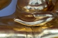 Close up to the palm of Buddha statue that rests on the lap. Beautiful shiny antique brass Buddha statue