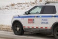 A Close up to a Peace Officer Patrol Car during a cold winter with snow