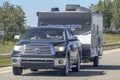 A close up to a pickup truck towing a RV trailer camper during summer on a highway Royalty Free Stock Photo