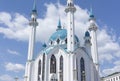 Close up to a Qol Sarif mosque exterior facade with blue turquoise domes and four white minarets shinning with blue sky