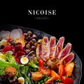 Close up to seafood French Nicoise salad with roasted tuna potato, tomato, lettuce, olives and quail eggs served on platter Royalty Free Stock Photo