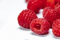 Close-up to several raspberries on white background. Healthy food, natural antioxidants.