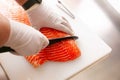 Close up to Slicing Cube Salmon by motion movement Knife by Prefessional Chef. Royalty Free Stock Photo