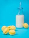 Sweet homemade macaroon cookies with bottle of milk in background,selective focus Royalty Free Stock Photo