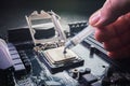 Close up to technician squeezing or application the thermal paste compound on the top of main cpu in the socket. Concept