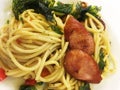 Close up to Thai pasta spaghetti with fried sausage in white dish Royalty Free Stock Photo