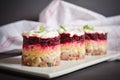 Portion of Layered fish salad Herring under fur coat served in culinary rings.