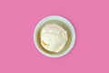 Close up to white cup of vanilla icecream serving on isolated pink background with blank copy space. Food, Dessert and Royalty Free Stock Photo