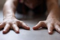 Close up to woman doing childs pose in yoga class at home