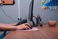 Close up to a work desk with the computer, keyboard and mouse. Woman& x27;s hands working at her desk. Royalty Free Stock Photo