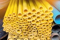 Close up to yellow plastic pipe background, PVC pipes stacked in warehouse Royalty Free Stock Photo