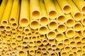 Close up to yellow plastic pipe background, PVC pipes stacked in warehouse Royalty Free Stock Photo