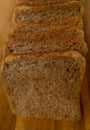 close-up toast appetizing fresh wholemeal bread with bran sliced in layers on wooden board, wheat, multigrain bread topview,