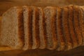 close-up toast appetizing fresh wholemeal bread with bran sliced in layers on wooden board, wheat, multigrain bread topview,