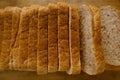 close-up toast appetizing fresh wholemeal bread with bran sliced in layers on wooden board, wheat, multigrain bread topview,