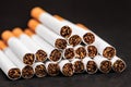 Close-up of tobacco cigarettes on a black background Royalty Free Stock Photo