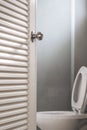 Close-up, Toilet door opening, with stationery ware, selective focus on door knob