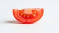 A close up of a tomato slice against a plain white background Royalty Free Stock Photo