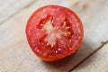 Close up of Tomato slice on wooden background - macro tomatoes Royalty Free Stock Photo