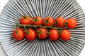 Close up of tomatoes on a patterned grey plate