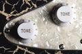 Close-up of tone and volume controls on an electric guitar Royalty Free Stock Photo