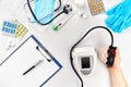 Close-up of tonometer by patients arm during blood pressure measuring at medical consultation