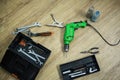 Close up of tool box and drill machine lying on floor Royalty Free Stock Photo