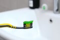 Close-up a toothbrush with green toothpaste for teeth in the bathroom Royalty Free Stock Photo