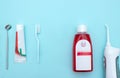 Close up of a toothbrush, toothpaste, irrigator, mouthwash for teeth, dental mirror on blurred blue background. Oral Care Concept Royalty Free Stock Photo