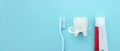 Close up of a toothbrush and toothpaste with white molar tooth model and Protective vortex around tooth on blurred blue background