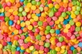 Close up top above overhead view photo of lot many thousands of colorful rainbow sugar icing textured background