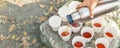 Close-up top above view woman hand hold steel thermos pouring hot tea many white paper cup group picnic mountain