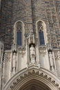 Close up of the top of the arched entryway and three statues above of the Duke University Chapel in Durham, North Carolina
